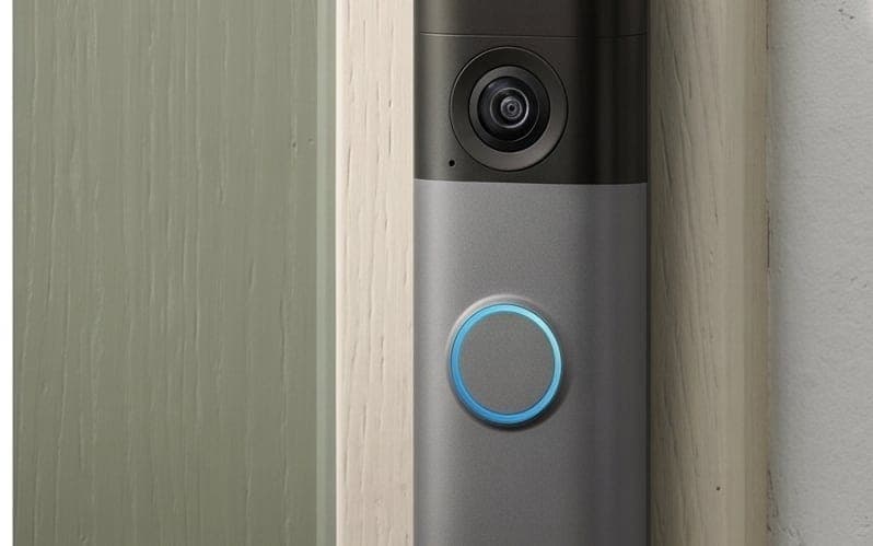 Video doorbell camera mounted beside a front door, the kind we install and connect to your network