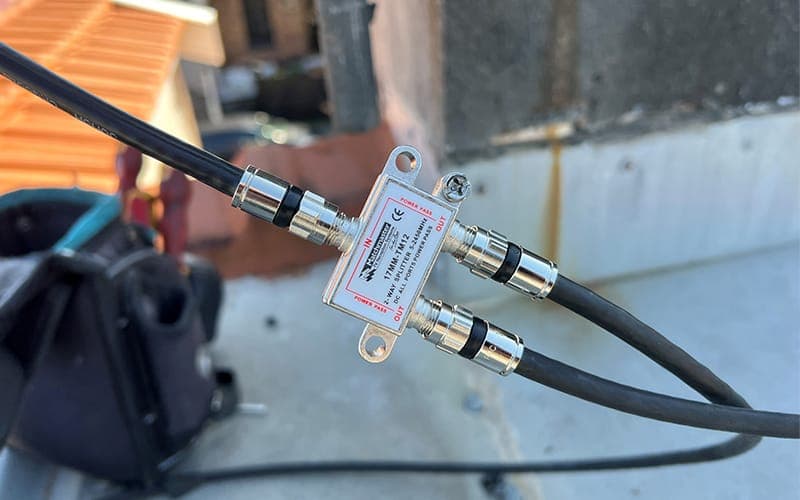 Coaxial splitter connected to antenna cabling on a rooftop