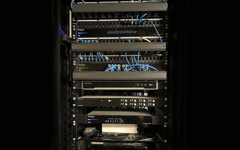 Floor-standing network rack with patch panels, switches and AV equipment