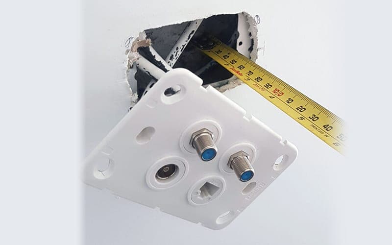 Wall plate removed to show a combined data and TV point with the wall cavity behind