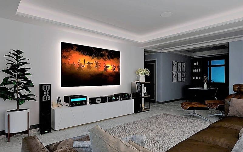 Living room home theatre with a large TV, AV rack and subwoofer on a white media unit
