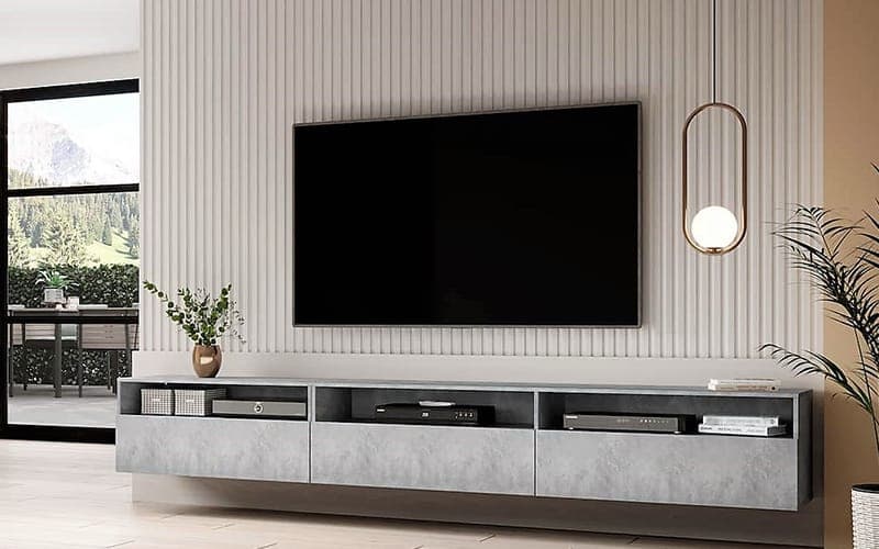 Large TV wall mounted on a fluted feature wall above a floating media cabinet