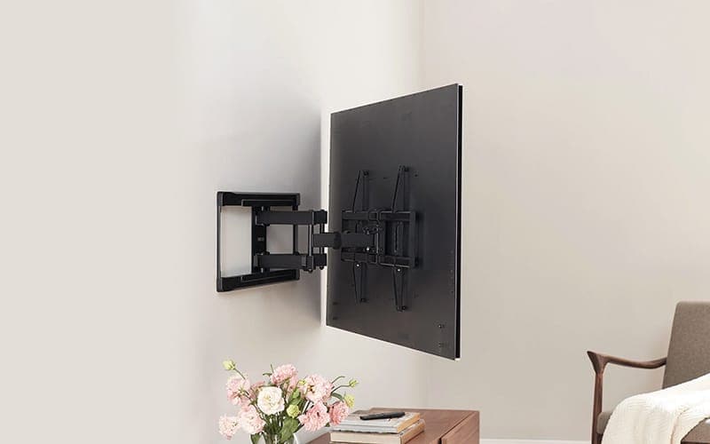 TV swung out from the wall on a cantilever bracket, showing the mounting arm behind the screen