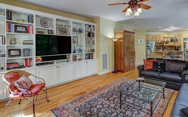 TV set into a white built-in bookcase wall unit in a family room