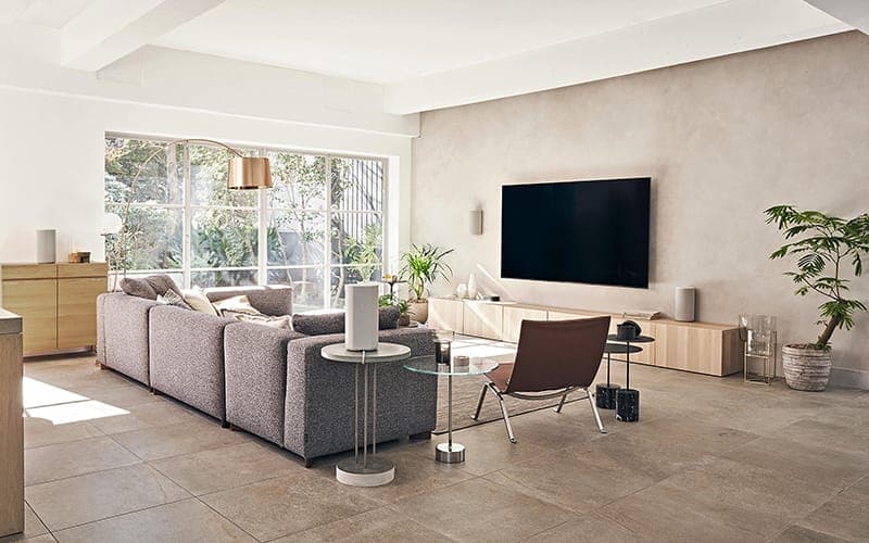 TV wall mounted on a rendered feature wall in an open-plan living room