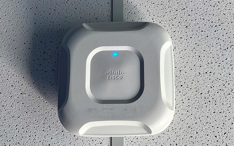 Cisco Wi-Fi access point mounted on a suspended ceiling tile